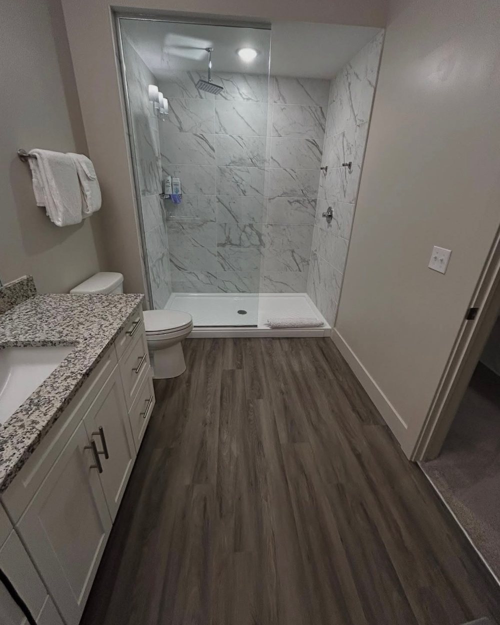 A marble tile shower and granite vanity after a BTI deep clean